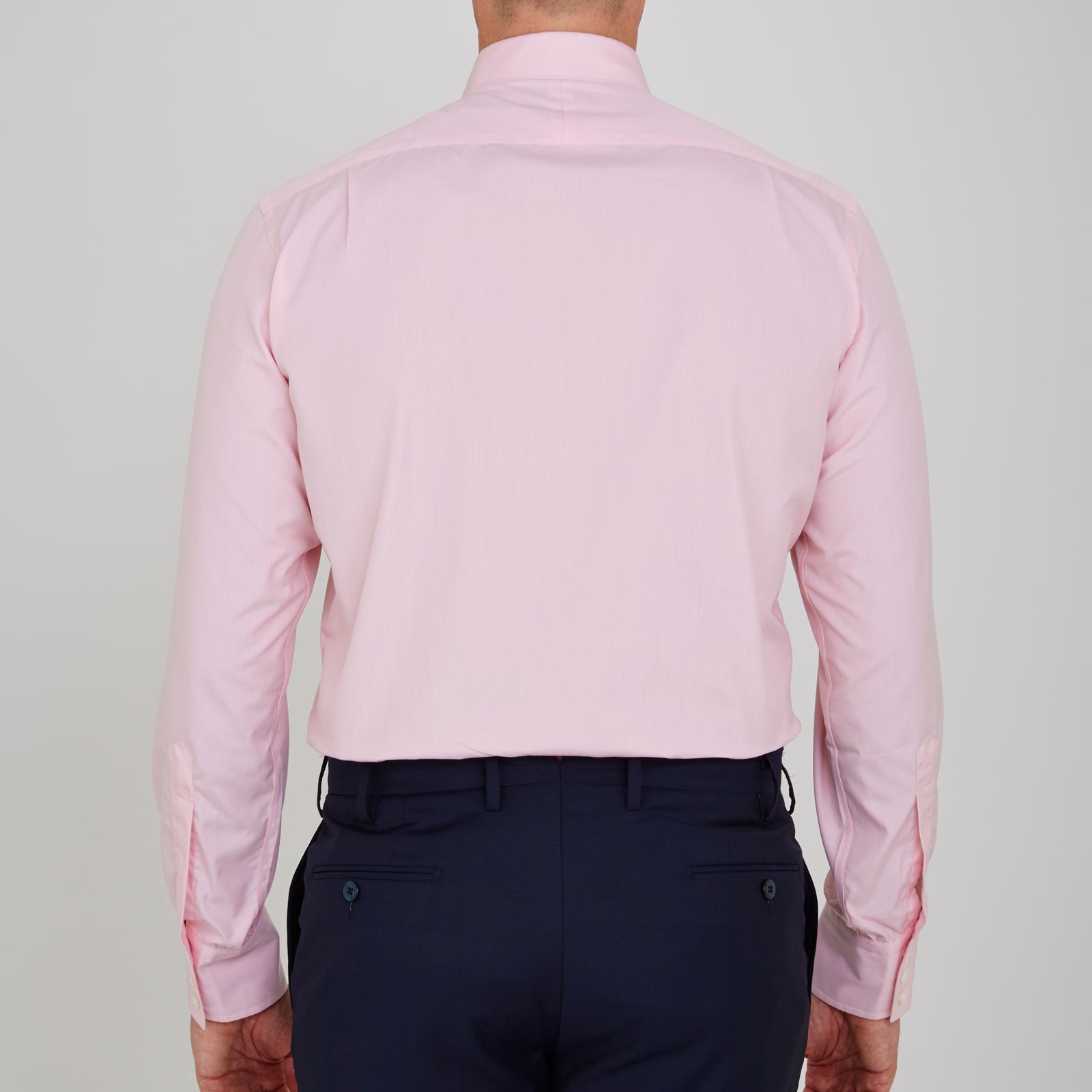 View 3 of product The Turnbull & Asser Pink End-on-End Shirt features a T&A collar, 3-button cuffs, and white buttons—a refined choice for any smart look—shown neatly folded against a plain white background.