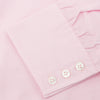 View 6 of product The Turnbull & Asser Pink End-on-End Shirt features a T&A collar, 3-button cuffs, and white buttons—a refined choice for any smart look—shown neatly folded against a plain white background.