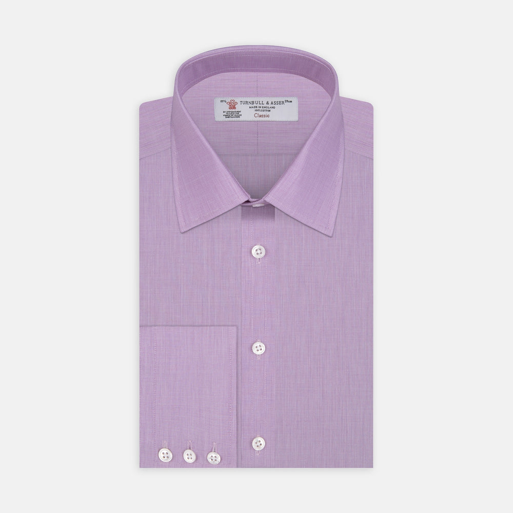 A neatly folded Turnbull & Asser Lilac End-on-End Shirt with T&A collar and 3-button cuffs, featuring white buttons and long sleeves, is displayed on a plain white background.