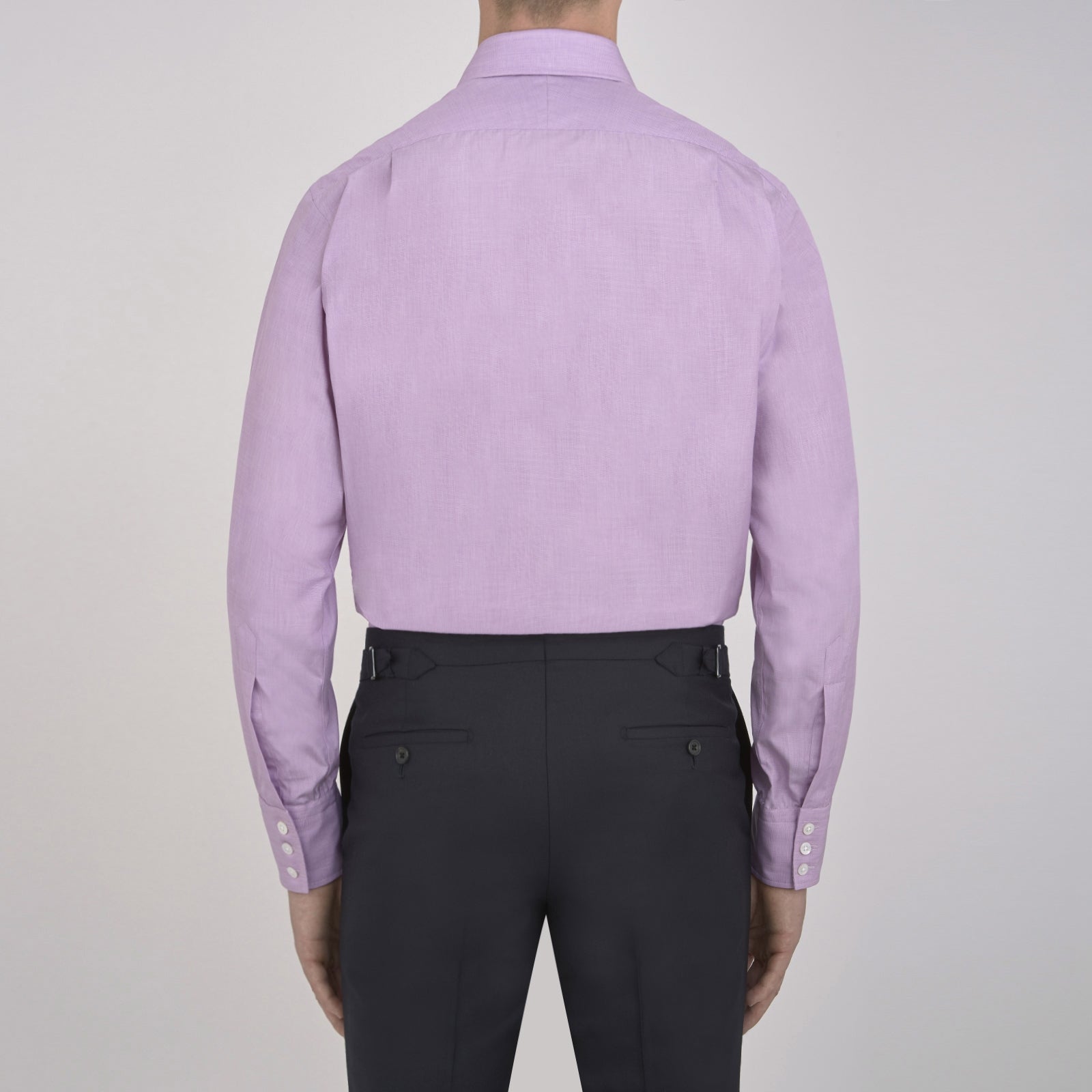 View 3 of product A neatly folded Turnbull & Asser Lilac End-on-End Shirt with T&A collar and 3-button cuffs, featuring white buttons and long sleeves, is displayed on a plain white background.
