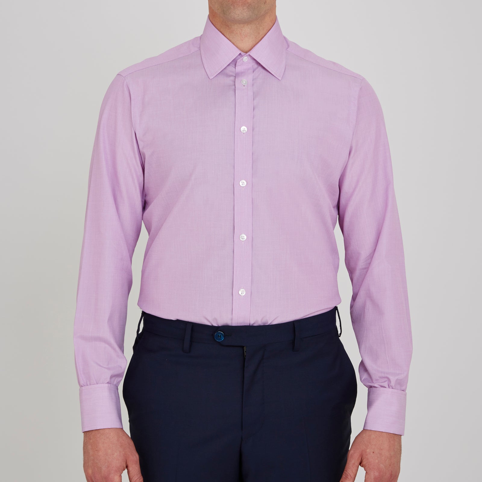 View 2 of product The Turnbull & Asser Lilac End-on-End Shirt features a T&A collar, double cuffs, and white buttons. Crafted from Italian two-tone cloth, this long-sleeved shirt is neatly folded and displayed on a plain white background.