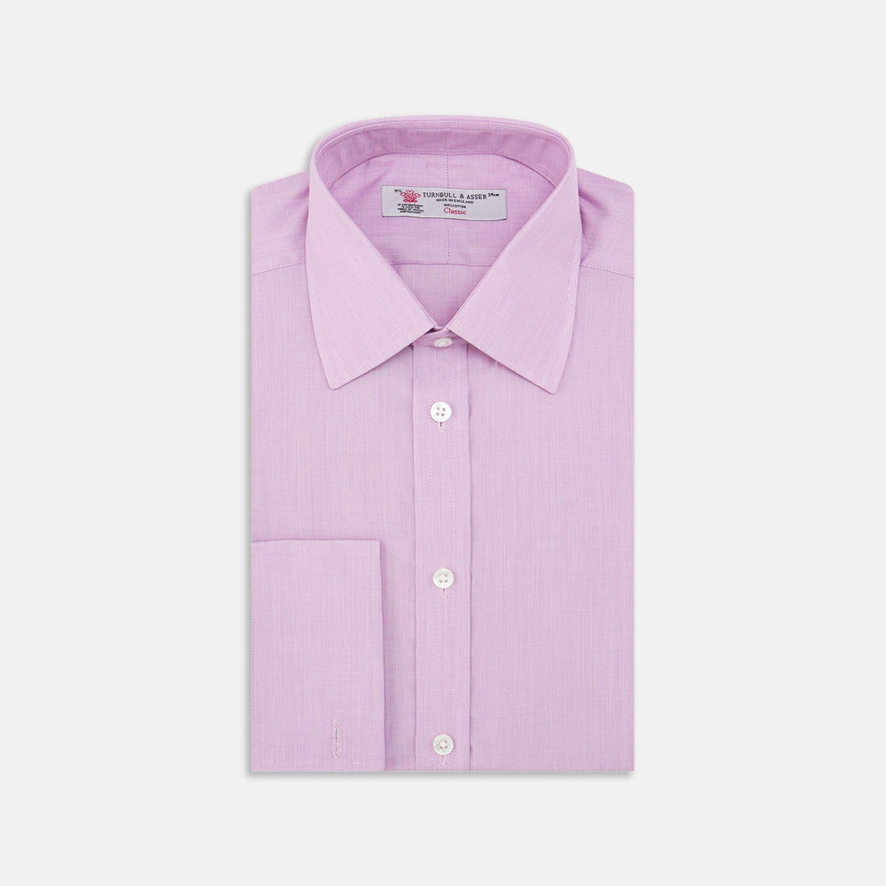 The Turnbull & Asser Lilac End-on-End Shirt features a T&A collar, double cuffs, and white buttons. Crafted from Italian two-tone cloth, this long-sleeved shirt is neatly folded and displayed on a plain white background.