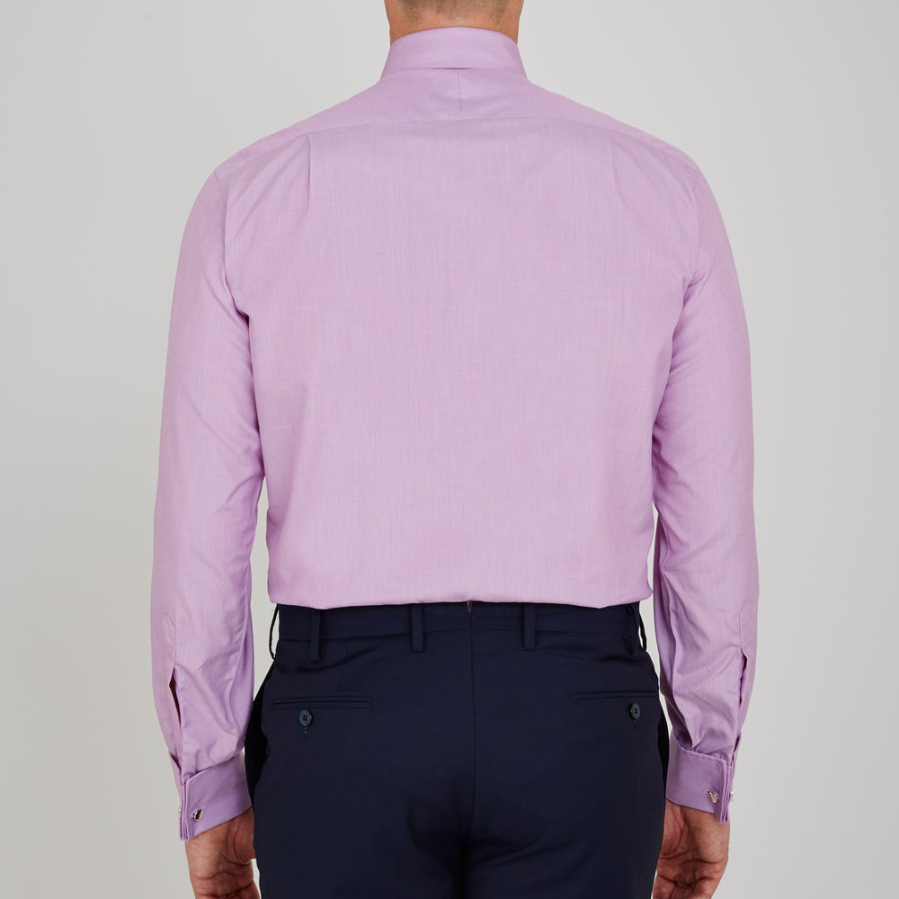 The Turnbull & Asser Lilac End-on-End Shirt features a T&A collar, double cuffs, and white buttons. Crafted from Italian two-tone cloth, this long-sleeved shirt is neatly folded and displayed on a plain white background.