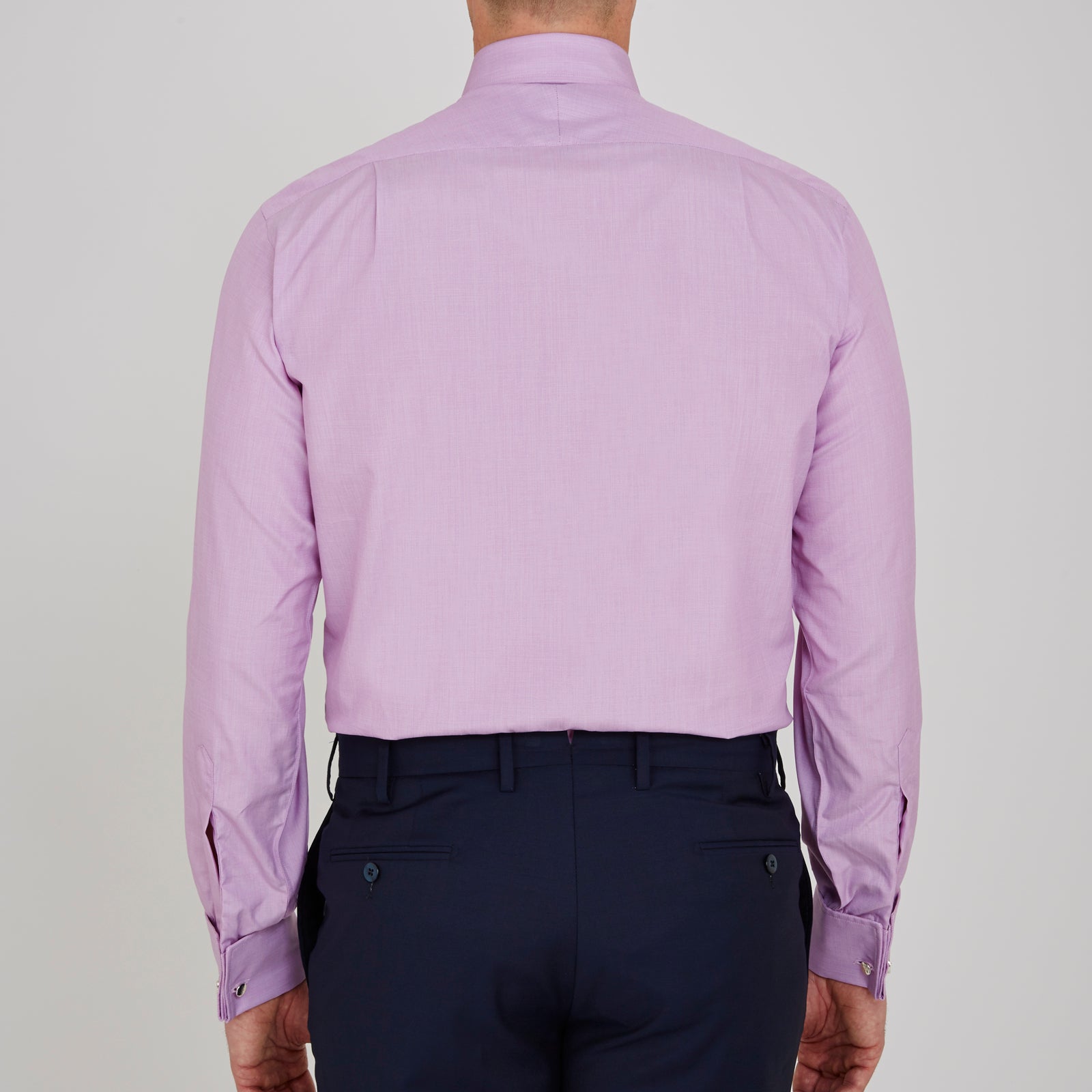 View 3 of product The Turnbull & Asser Lilac End-on-End Shirt features a T&A collar, double cuffs, and white buttons. Crafted from Italian two-tone cloth, this long-sleeved shirt is neatly folded and displayed on a plain white background.