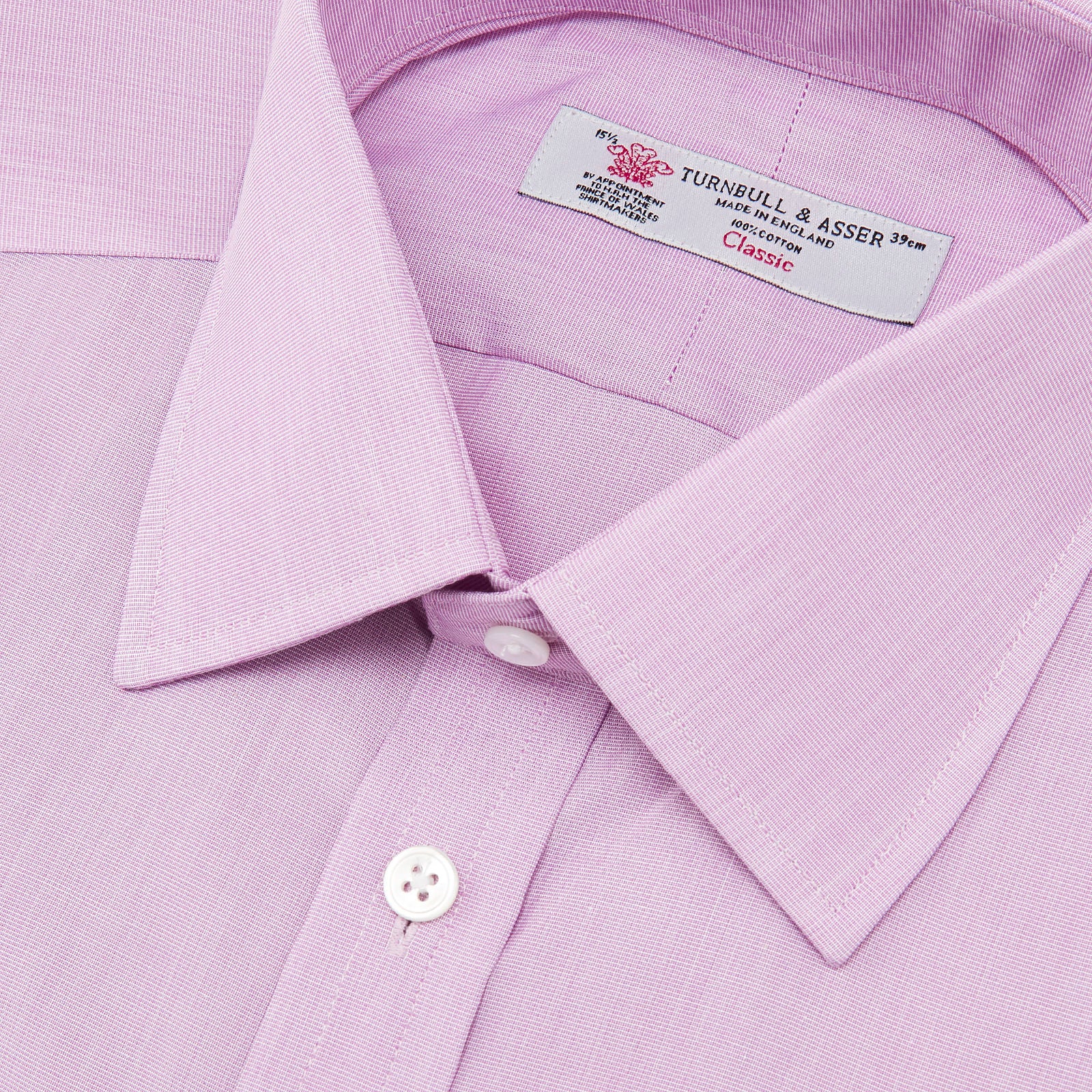 View 5 of product The Turnbull & Asser Lilac End-on-End Shirt features a T&A collar, double cuffs, and white buttons. Crafted from Italian two-tone cloth, this long-sleeved shirt is neatly folded and displayed on a plain white background.