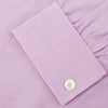 View 6 of product The Turnbull & Asser Lilac End-on-End Shirt features a T&A collar, double cuffs, and white buttons. Crafted from Italian two-tone cloth, this long-sleeved shirt is neatly folded and displayed on a plain white background.