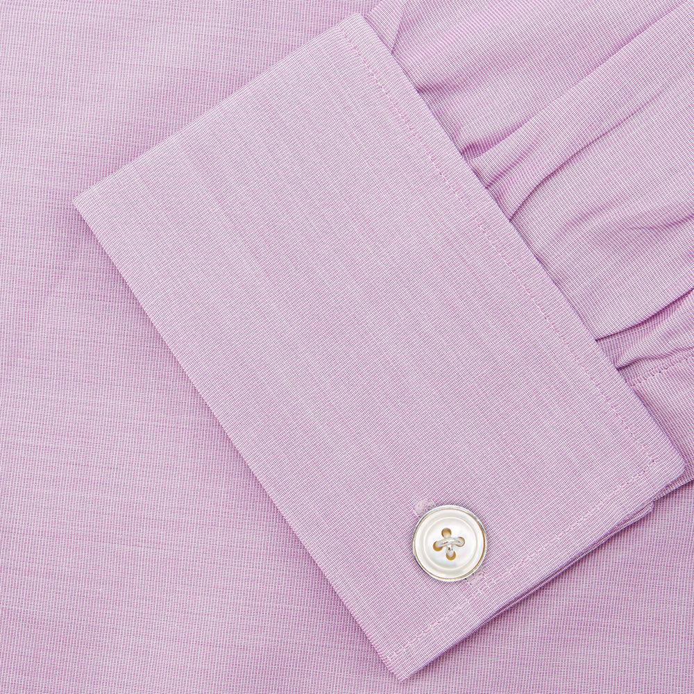 The Turnbull & Asser Lilac End-on-End Shirt features a T&A collar, double cuffs, and white buttons. Crafted from Italian two-tone cloth, this long-sleeved shirt is neatly folded and displayed on a plain white background.