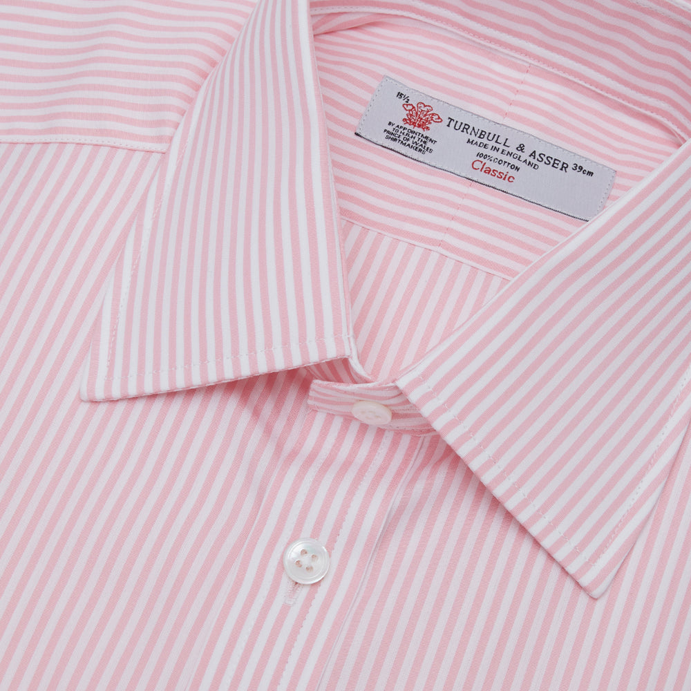 A neatly folded Turnbull & Asser blue shirt with a regent collar and 2-button cocktail cuffs, displayed against a plain white background.