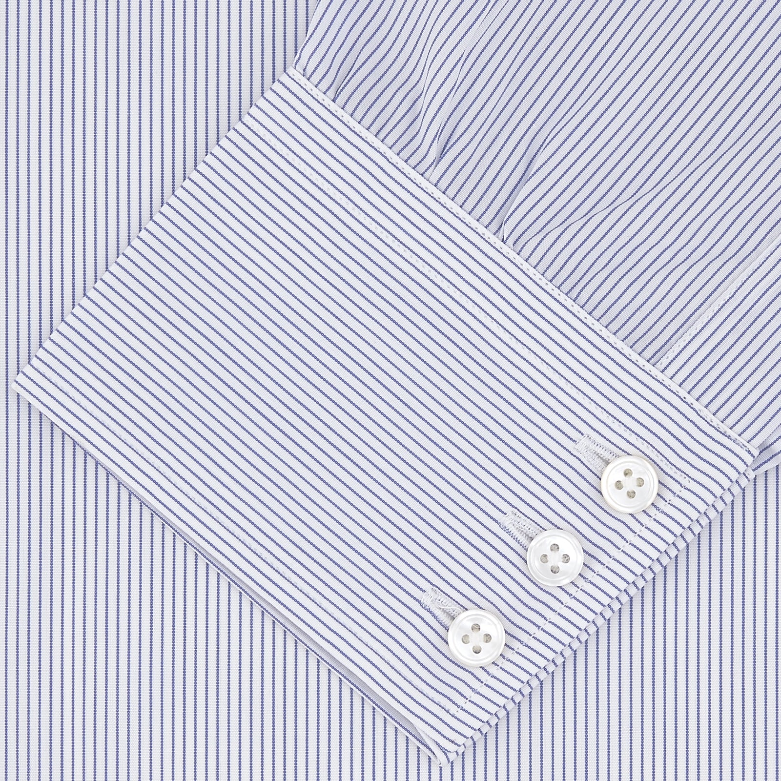 View 2 of product The Turnbull & Asser Blue and White Fine Stripe Shirt features a T&A collar, 3-button cuffs, and white buttons, shown neatly folded on a white background.