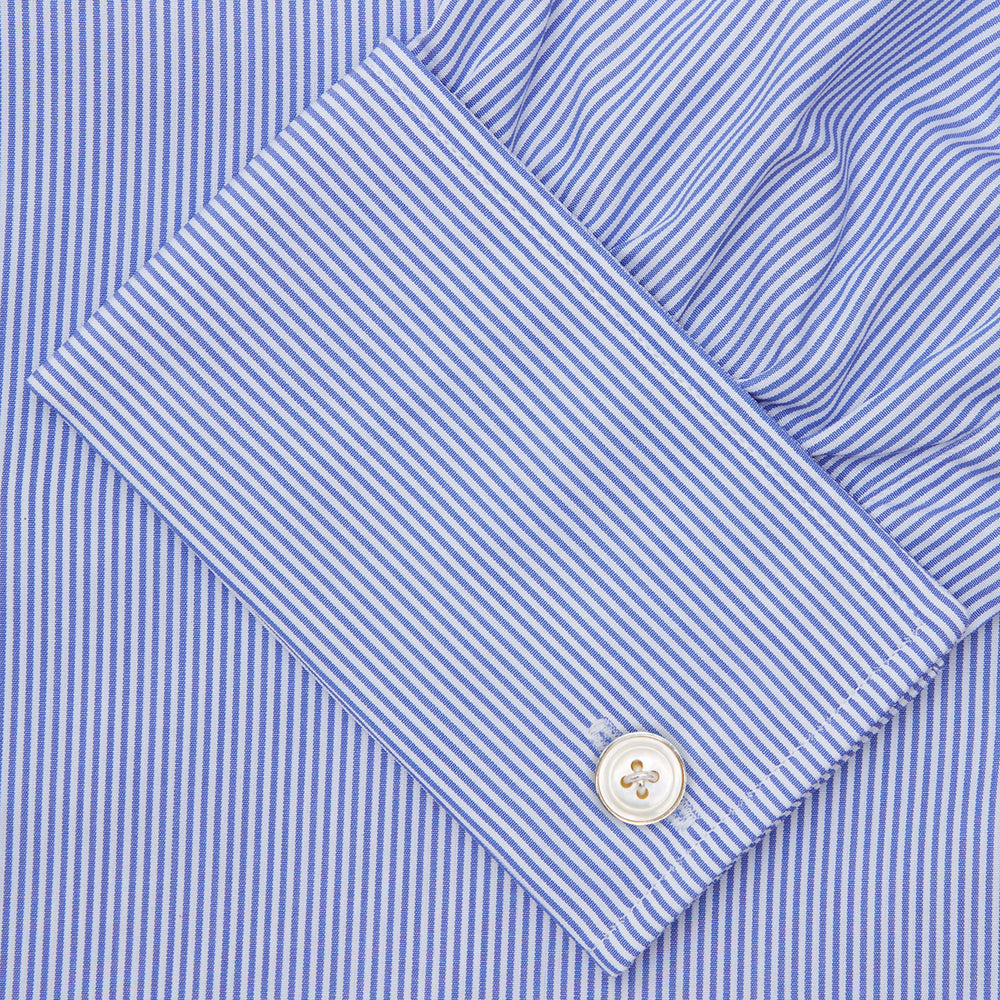 The Turnbull & Asser Blue Fine Bengal Stripe Shirt features a T&A collar, double cuffs, and white buttons, neatly folded and displayed against a plain white background.