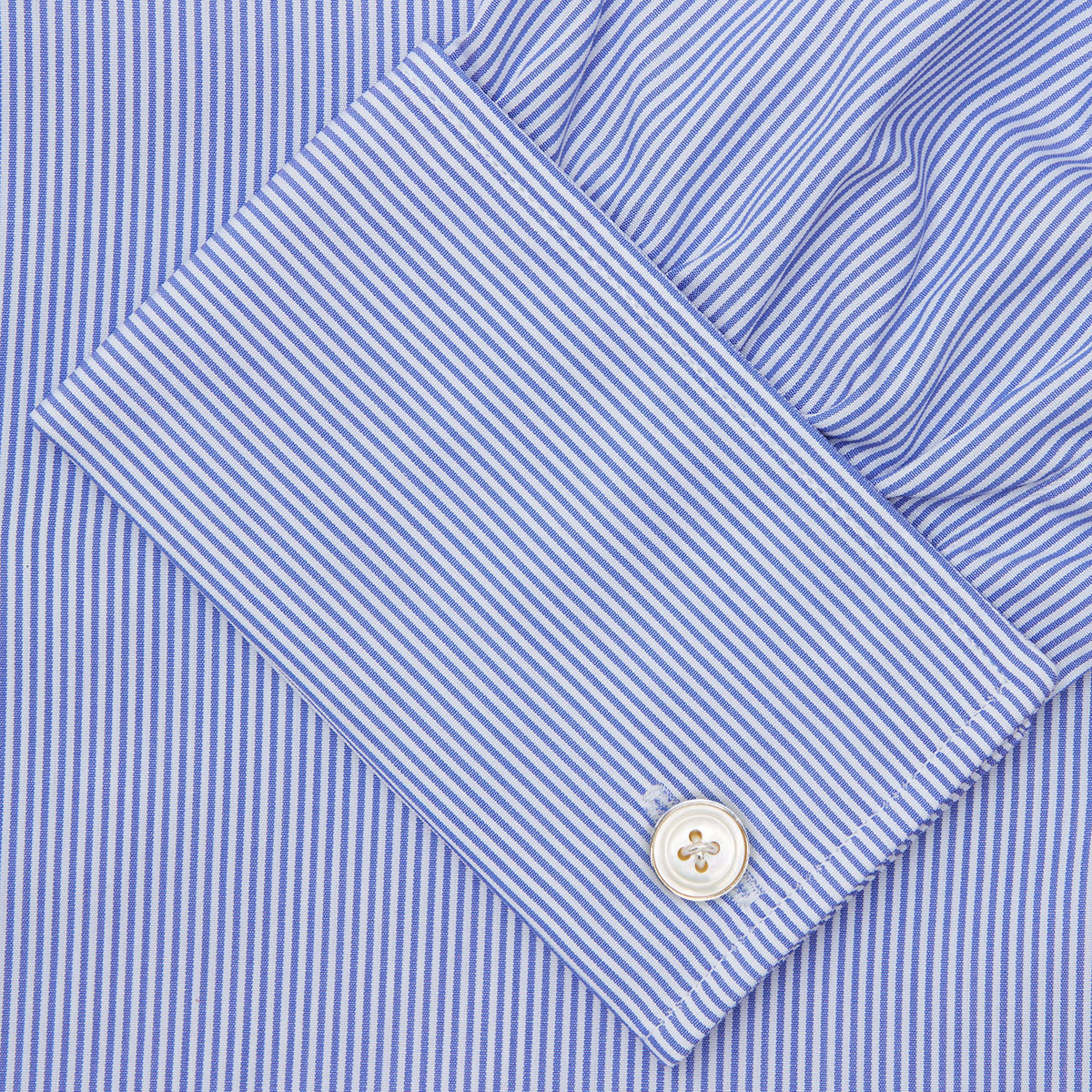 View 6 of product The Turnbull & Asser Blue Fine Bengal Stripe Shirt features a T&A collar, double cuffs, and white buttons, neatly folded and displayed against a plain white background.