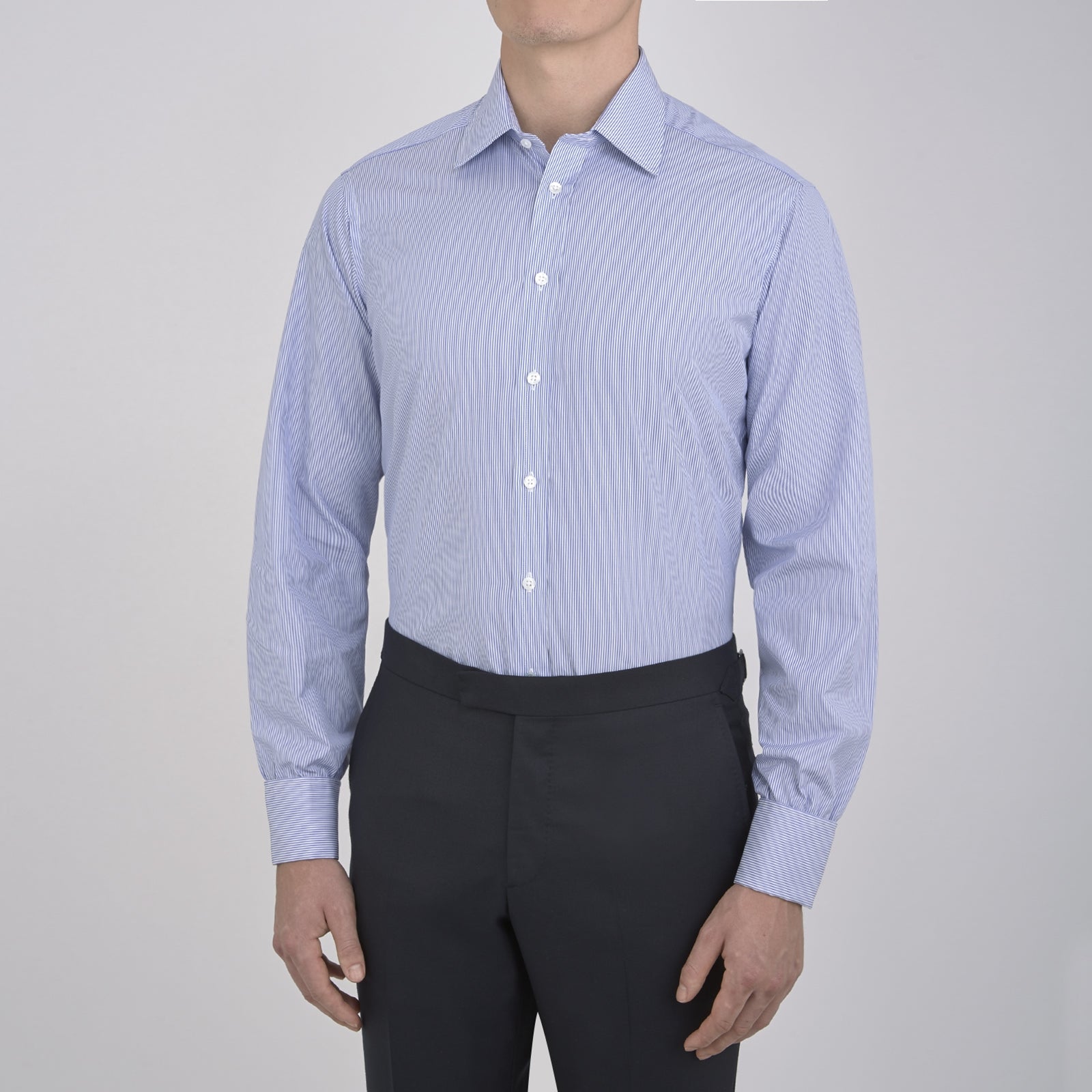 View 2 of product The Turnbull & Asser Blue Fine Bengal Stripe Shirt features a T&A collar, double cuffs, and white buttons, neatly folded and displayed against a plain white background.