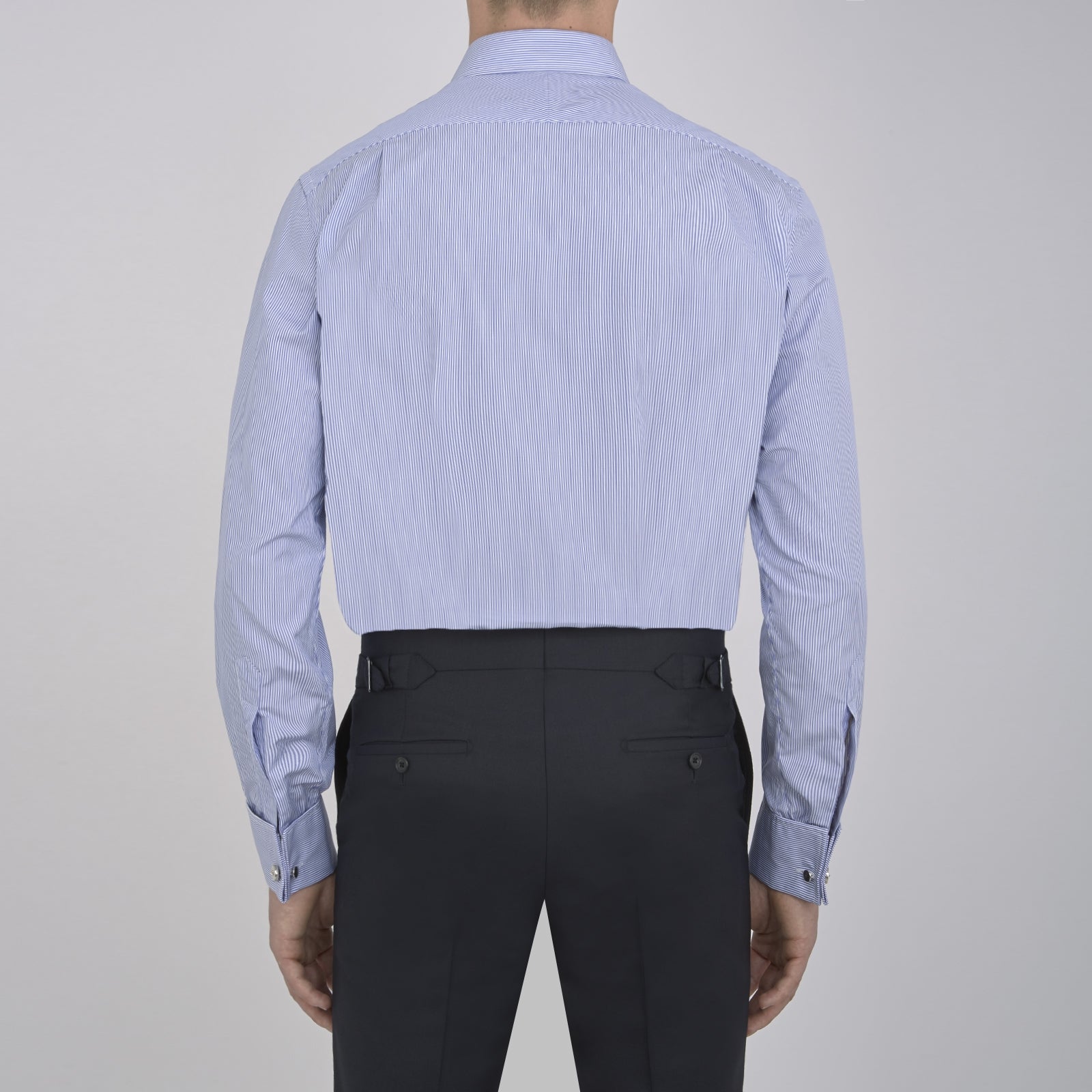 View 3 of product The Turnbull & Asser Blue Fine Bengal Stripe Shirt features a T&A collar, double cuffs, and white buttons, neatly folded and displayed against a plain white background.