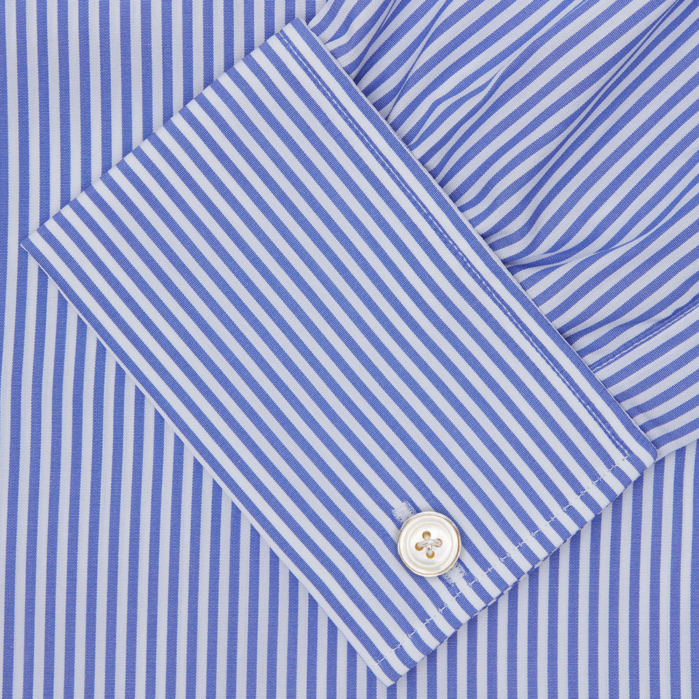 The Turnbull & Asser Blue Bengal Stripe Shirt features a T&A collar, double cuffs, and crisp white buttons. Made from cotton with blue and white bengal stripes, it’s neatly folded and displayed on a white background.
