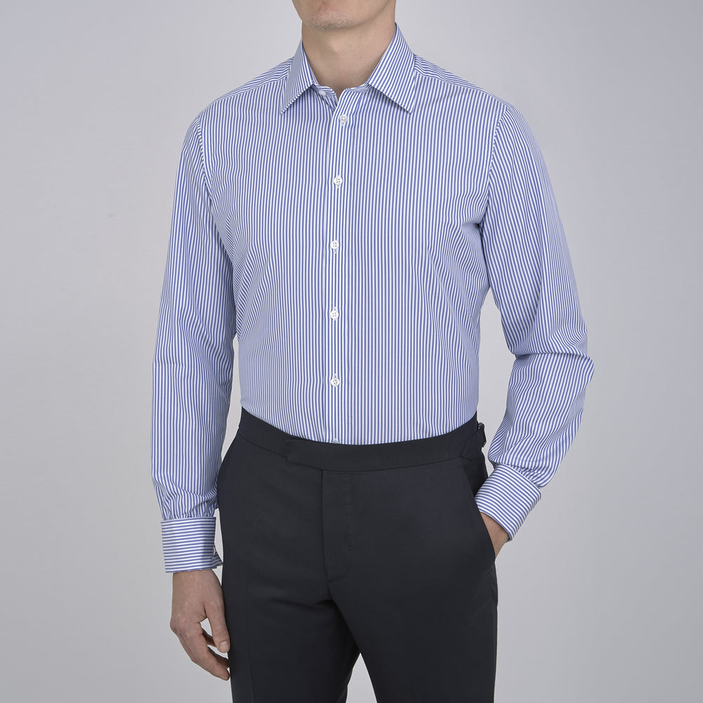 The Turnbull & Asser Blue Bengal Stripe Shirt features a T&A collar, double cuffs, and crisp white buttons. Made from cotton with blue and white bengal stripes, it’s neatly folded and displayed on a white background.