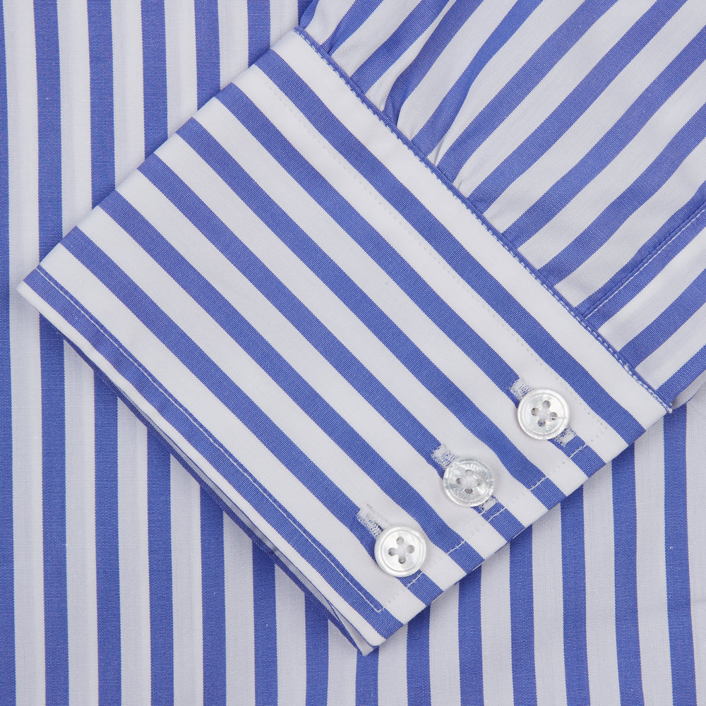 The Turnbull & Asser Blue and White Candy Stripe Shirt features a T&A collar, 3-button cuffs, and crisp white buttons, displayed neatly folded against a white background for a classic look.
