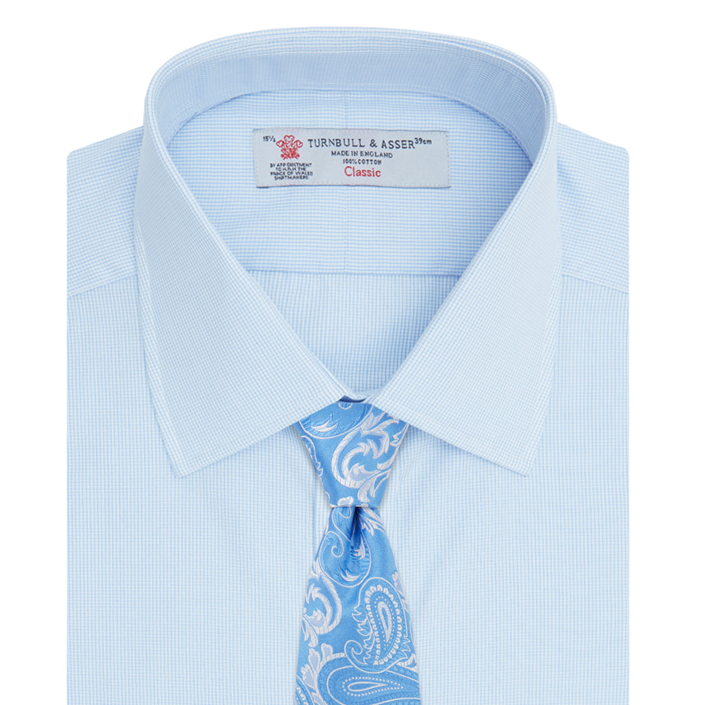 The Turnbull & Asser Light Blue Fine Check Shirt for men features a T&A collar, 3-button cuffs, classic white buttons, and a refined check design with a visible label inside the collar.