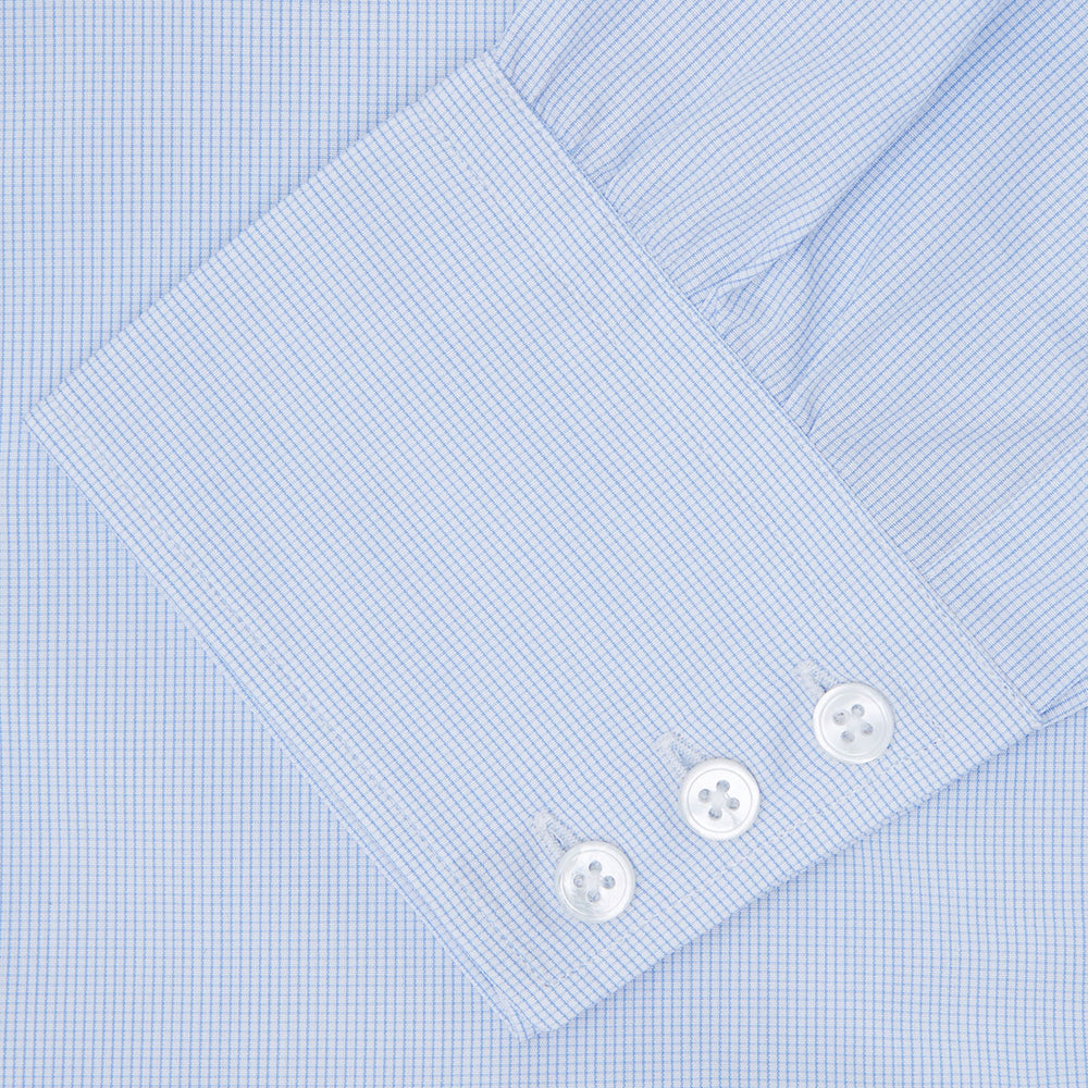 The Turnbull & Asser Light Blue Fine Check Shirt for men features a T&A collar, 3-button cuffs, classic white buttons, and a refined check design with a visible label inside the collar.
