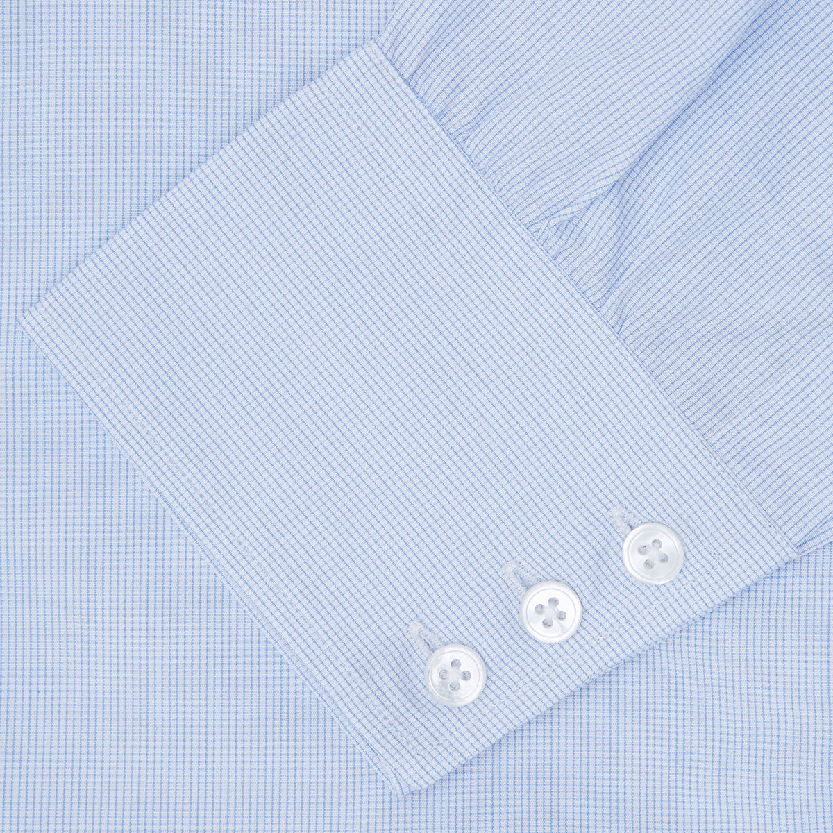 View 6 of product The Turnbull & Asser Light Blue Fine Check Shirt for men features a T&A collar, 3-button cuffs, classic white buttons, and a refined check design with a visible label inside the collar.