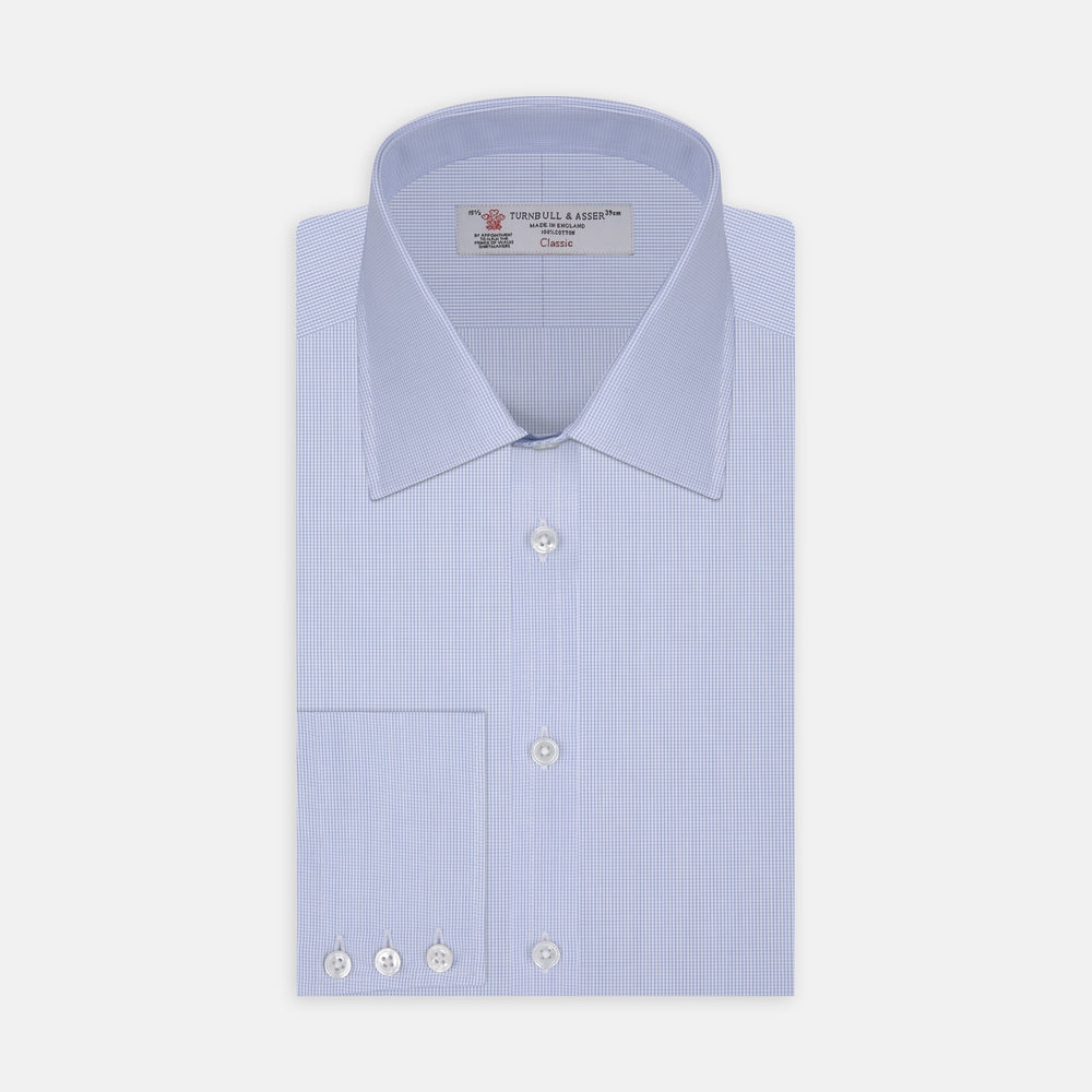 The Turnbull & Asser Light Blue Fine Check Shirt for men features a T&A collar, 3-button cuffs, classic white buttons, and a refined check design with a visible label inside the collar.