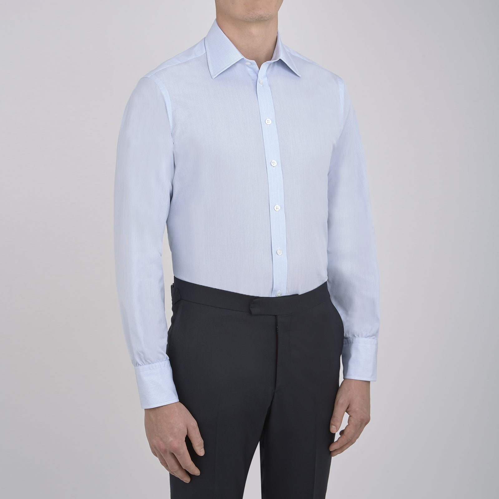 View 2 of product The Turnbull & Asser Light Blue Fine Check Shirt for men features a T&A collar, 3-button cuffs, classic white buttons, and a refined check design with a visible label inside the collar.