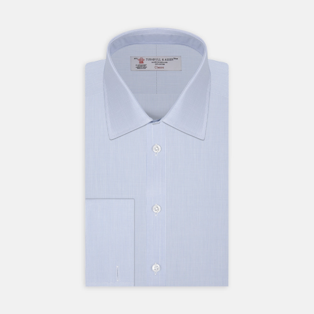 Turnbull & Asser’s Light Blue Fine Check Shirt features a T&A collar, double cuffs, and a subtle checked cotton pattern, neatly displayed on a white background for a classic smart look.