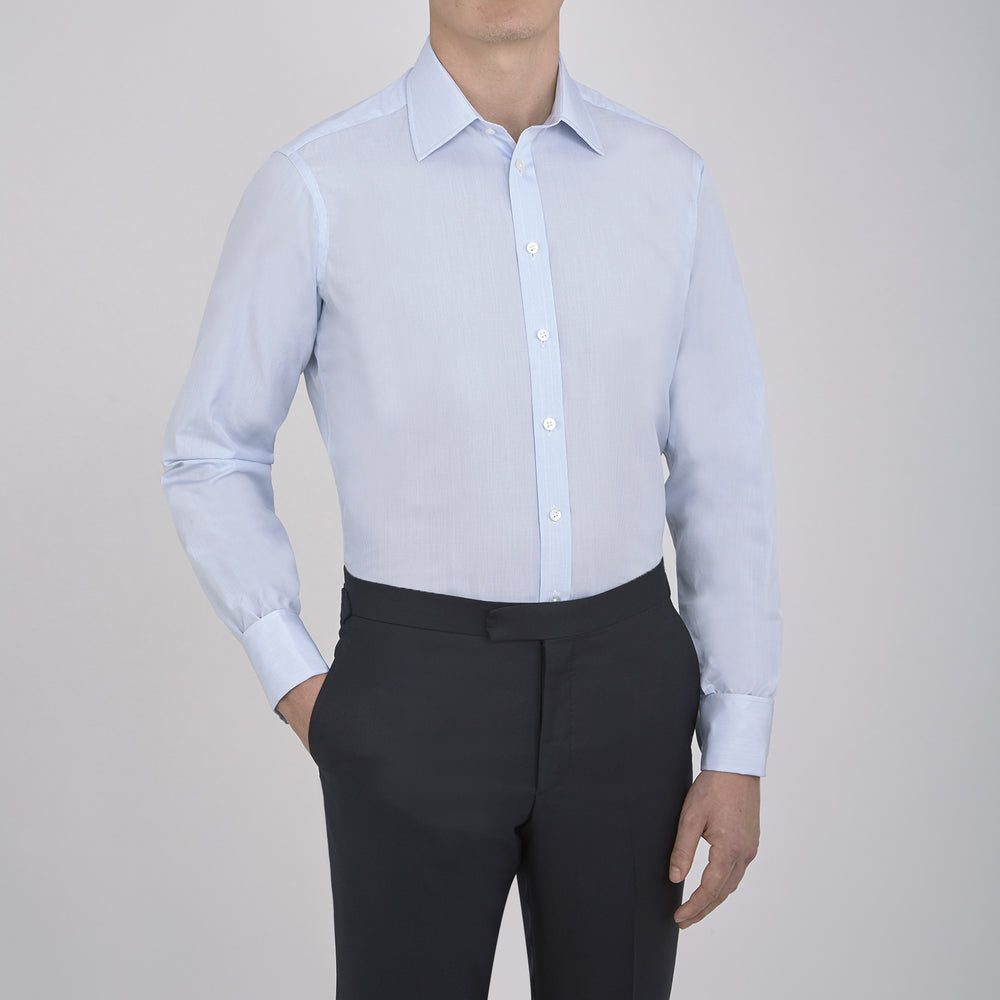 Turnbull & Asser’s Light Blue Fine Check Shirt features a T&A collar, double cuffs, and a subtle checked cotton pattern, neatly displayed on a white background for a classic smart look.