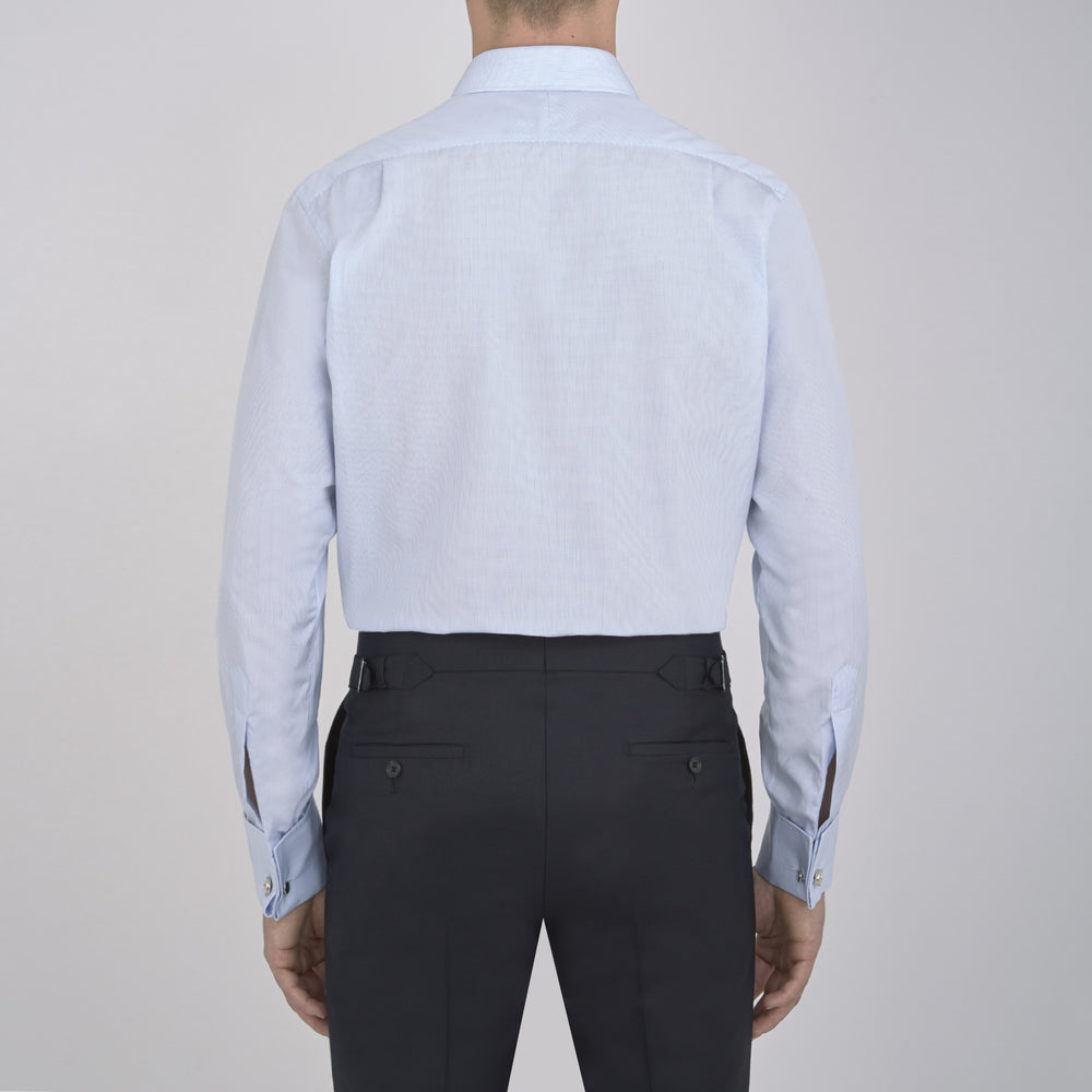 Turnbull & Asser’s Light Blue Fine Check Shirt features a T&A collar, double cuffs, and a subtle checked cotton pattern, neatly displayed on a white background for a classic smart look.