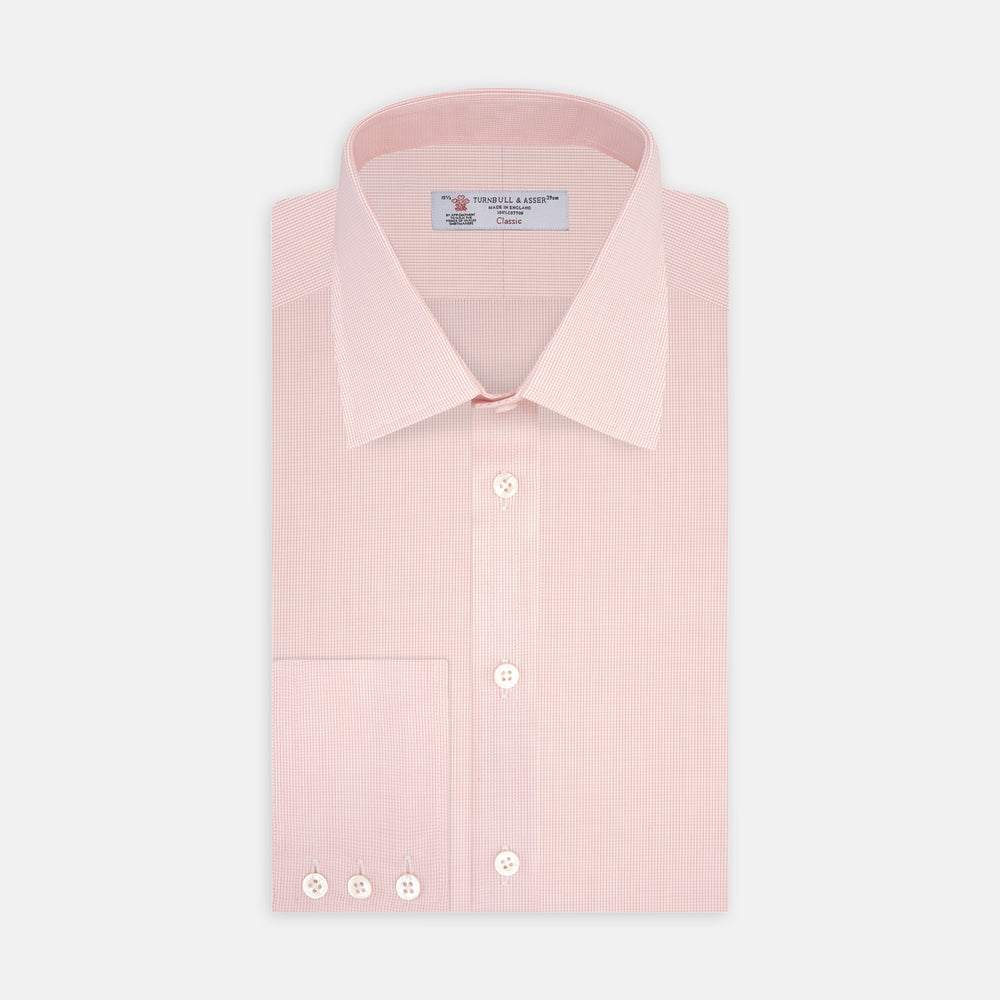 The Turnbull & Asser Pink Fine Check Shirt features a T&A collar, 3-button cuffs, and a subtle pink check design, made from fine cotton. Displayed neatly folded against a plain backdrop.