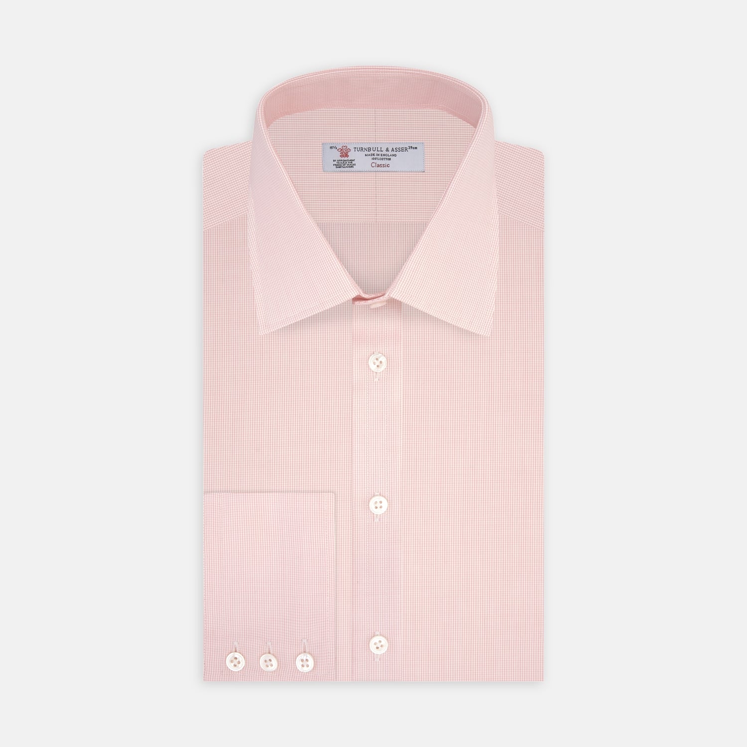 View 1 of product The Turnbull & Asser Pink Fine Check Shirt features a T&A collar, 3-button cuffs, and a subtle pink check design, made from fine cotton. Displayed neatly folded against a plain backdrop.
