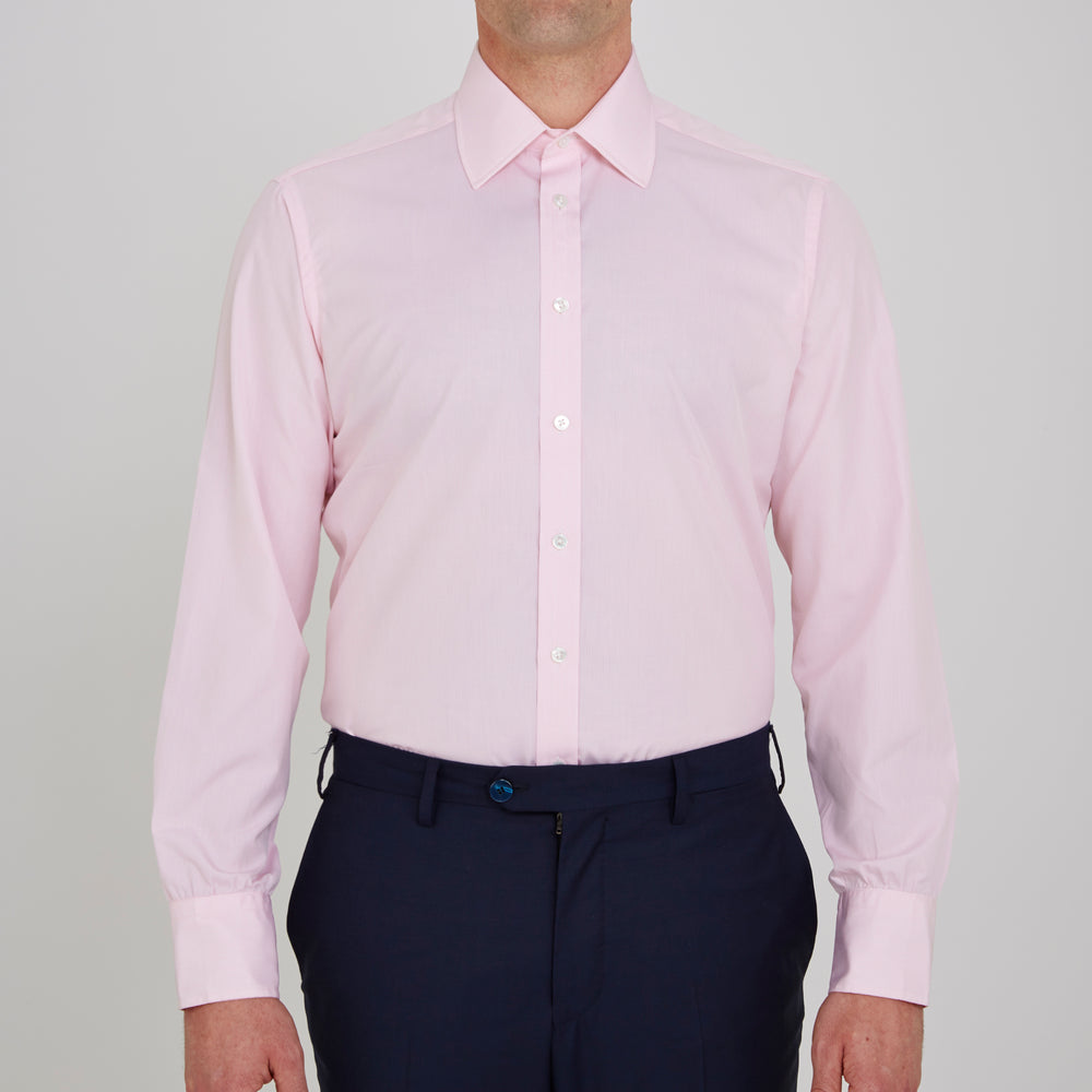 The Turnbull & Asser Pink Fine Check Shirt features a T&A collar, 3-button cuffs, and a subtle pink check design, made from fine cotton. Displayed neatly folded against a plain backdrop.