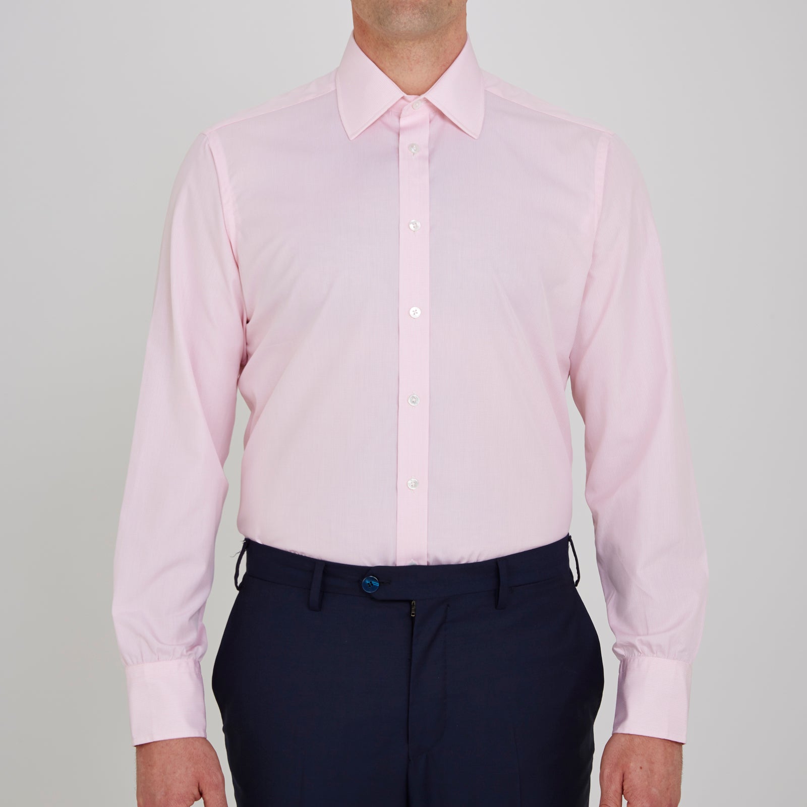 View 2 of product The Turnbull & Asser Pink Fine Check Shirt features a T&A collar, 3-button cuffs, and a subtle pink check design, made from fine cotton. Displayed neatly folded against a plain backdrop.