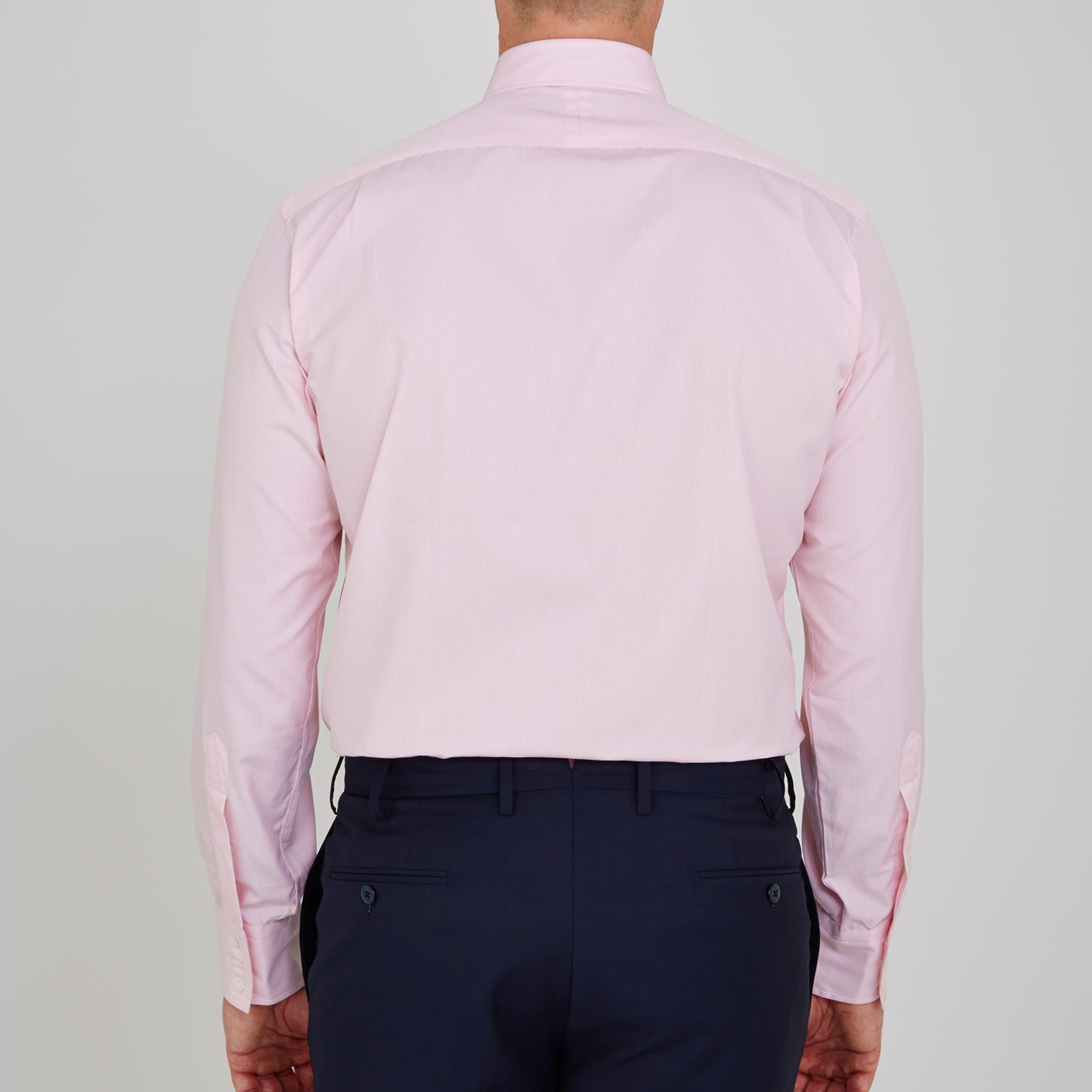 View 3 of product The Turnbull & Asser Pink Fine Check Shirt features a T&A collar, 3-button cuffs, and a subtle pink check design, made from fine cotton. Displayed neatly folded against a plain backdrop.