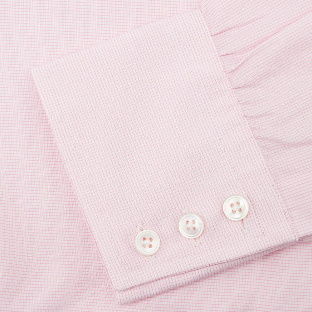 The Turnbull & Asser Pink Fine Check Shirt features a T&A collar, 3-button cuffs, and a subtle pink check design, made from fine cotton. Displayed neatly folded against a plain backdrop.