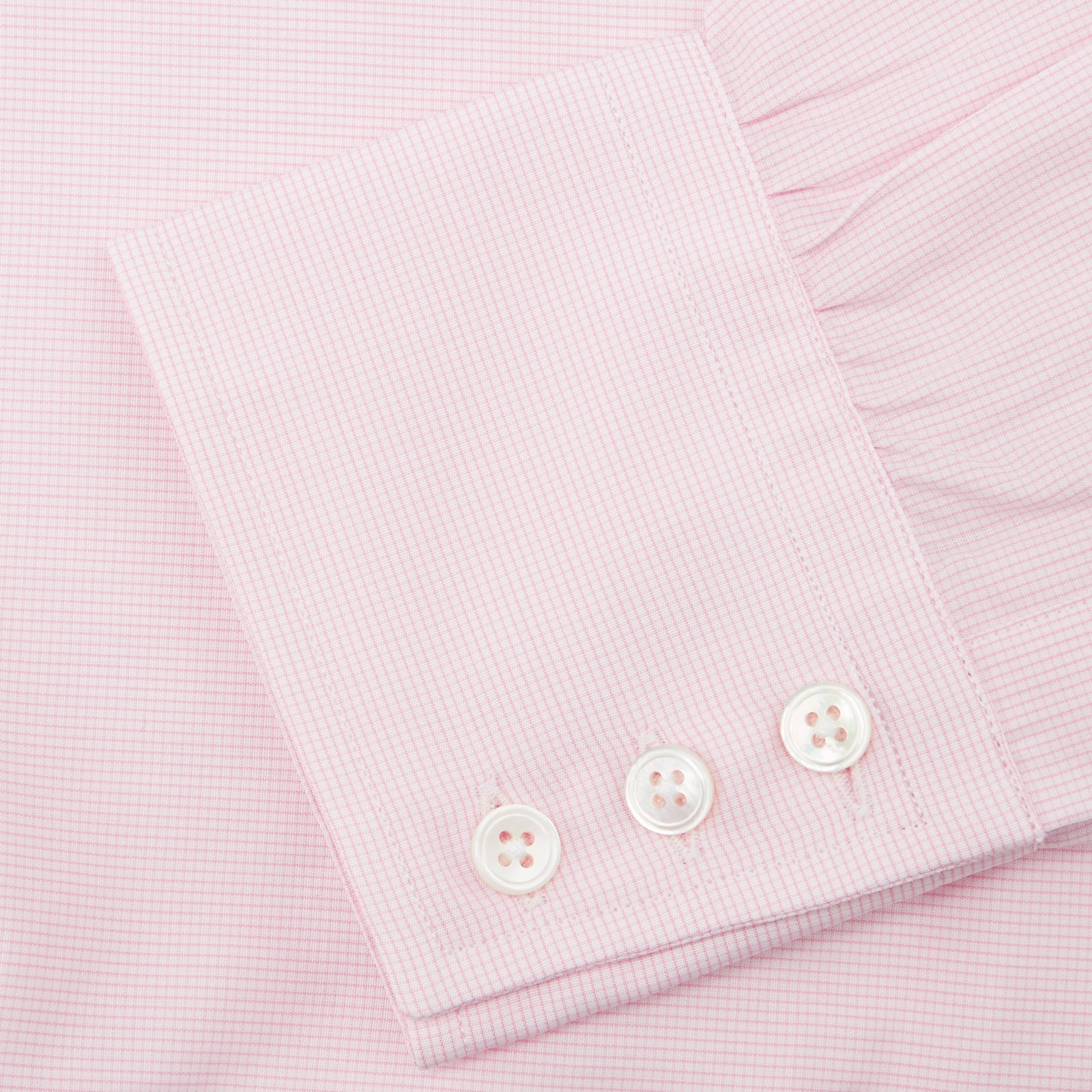 View 6 of product The Turnbull & Asser Pink Fine Check Shirt features a T&A collar, 3-button cuffs, and a subtle pink check design, made from fine cotton. Displayed neatly folded against a plain backdrop.