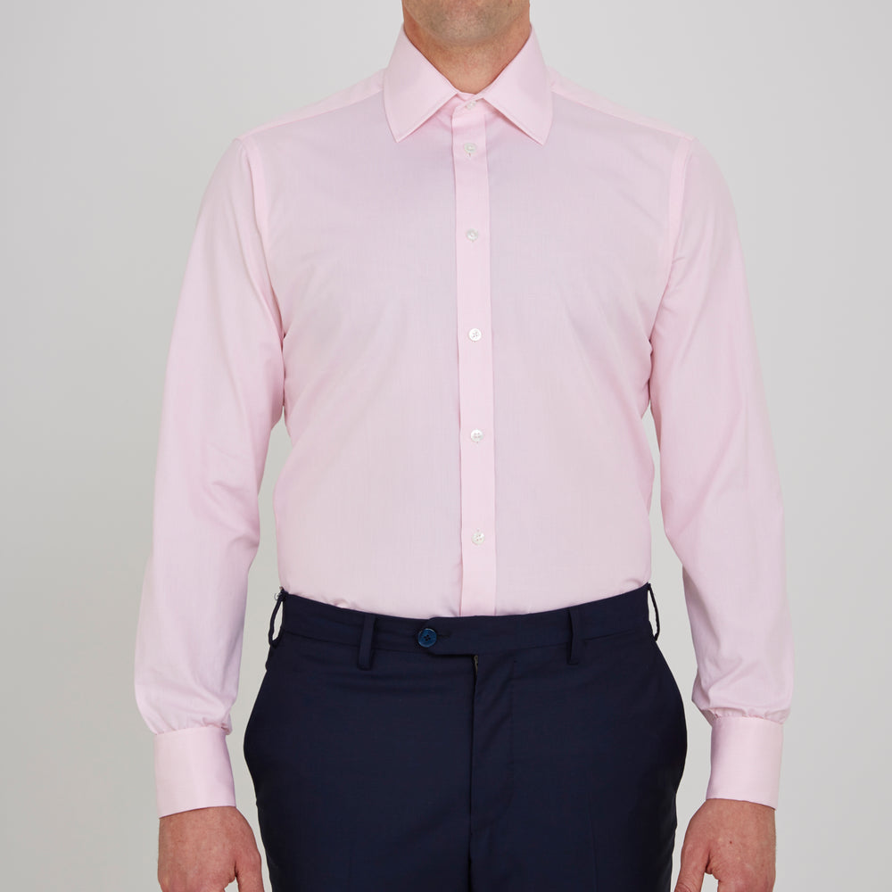 The Turnbull & Asser Pink Fine Check Shirt features a T&A collar, double cuffs, and classic white buttons, neatly folded and displayed against a plain white background.