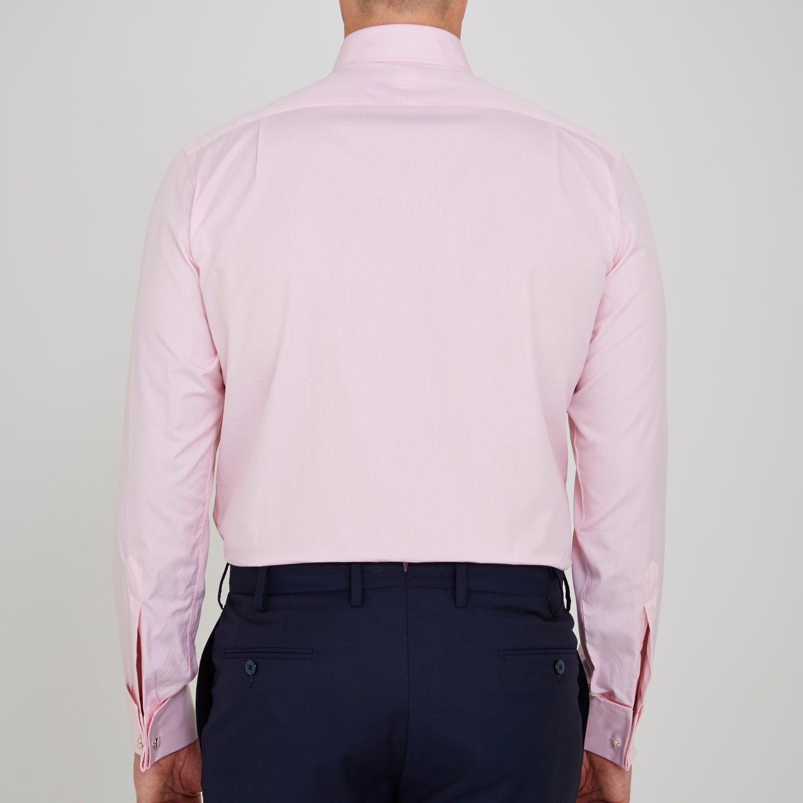 View 3 of product The Turnbull & Asser Pink Fine Check Shirt features a T&A collar, double cuffs, and classic white buttons, neatly folded and displayed against a plain white background.