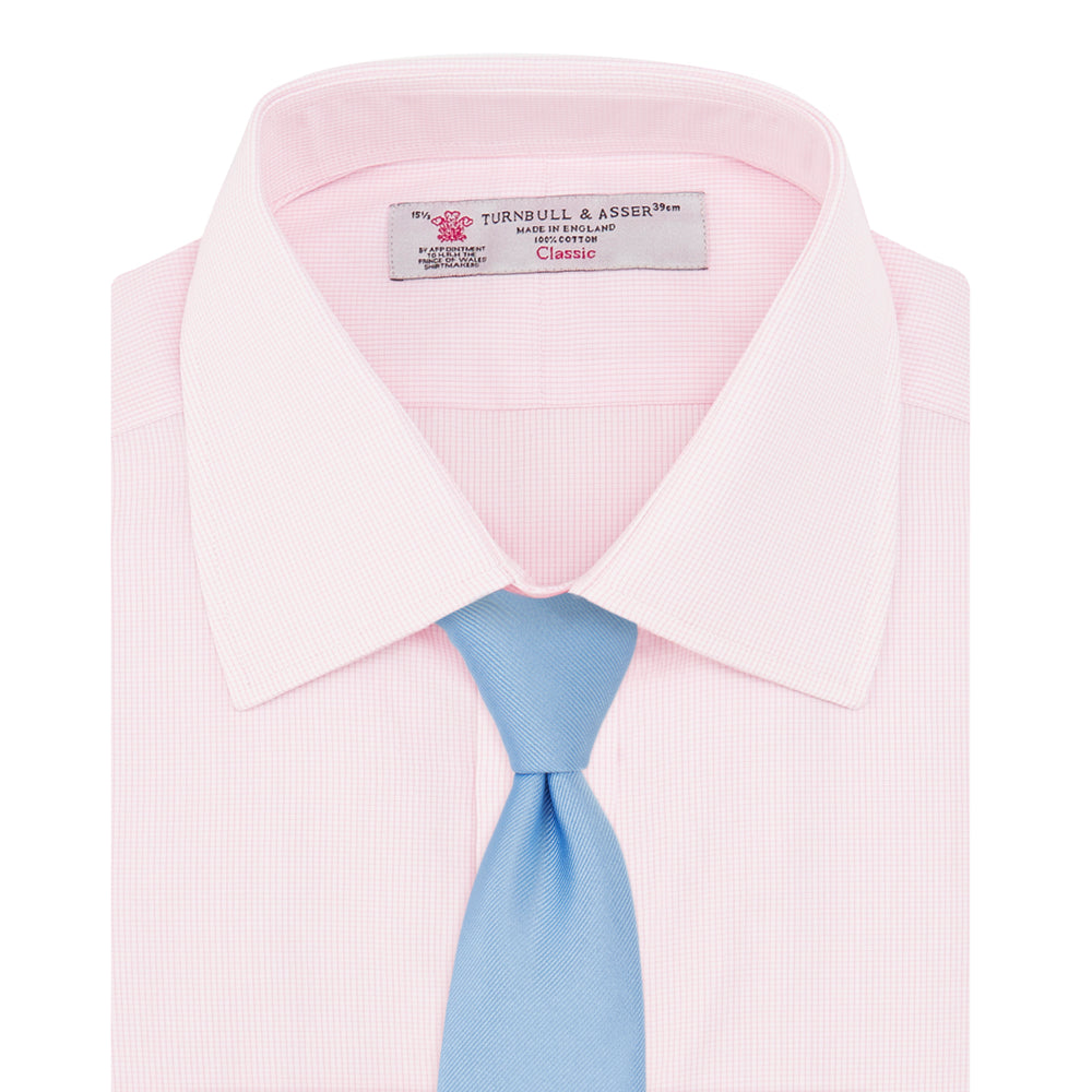 The Turnbull & Asser Pink Fine Check Shirt features a T&A collar, double cuffs, and classic white buttons, neatly folded and displayed against a plain white background.