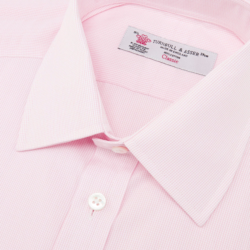 The Turnbull & Asser Pink Fine Check Shirt features a T&A collar, double cuffs, and classic white buttons, neatly folded and displayed against a plain white background.