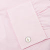 View 6 of product The Turnbull & Asser Pink Fine Check Shirt features a T&A collar, double cuffs, and classic white buttons, neatly folded and displayed against a plain white background.