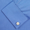 View 6 of product A neatly folded, dark blue end-on-end men's dress shirt by Turnbull & Asser, featuring a T&A collar and double cuffs, is displayed against a plain white background.
