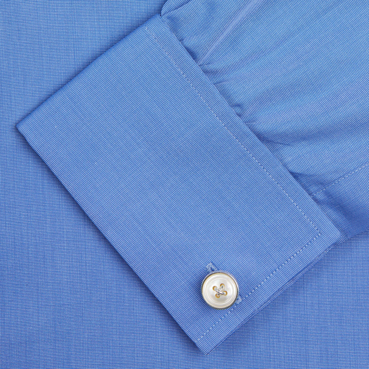 View 6 of product A neatly folded, dark blue end-on-end men's dress shirt by Turnbull & Asser, featuring a T&A collar and double cuffs, is displayed against a plain white background.