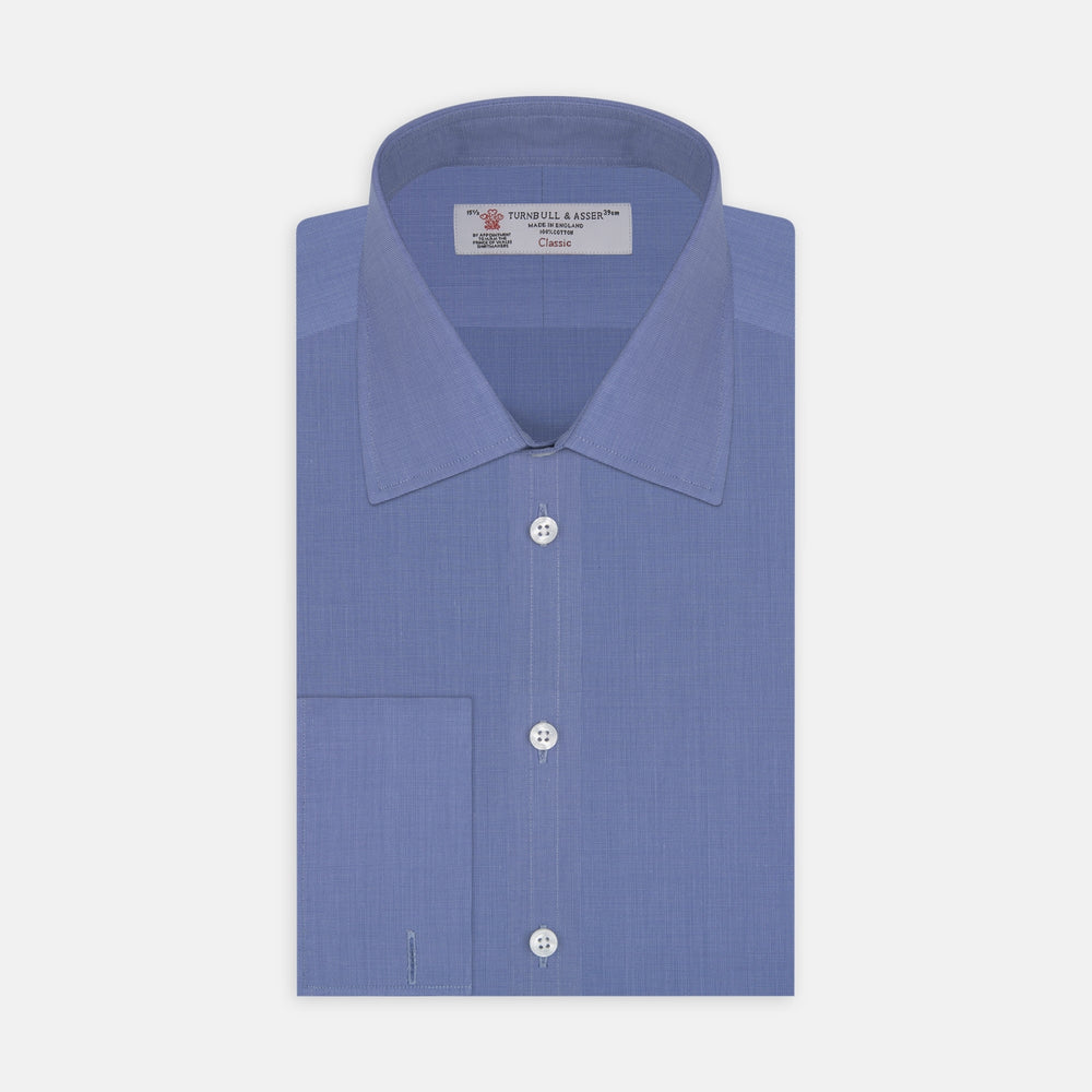 A neatly folded, dark blue end-on-end men's dress shirt by Turnbull & Asser, featuring a T&A collar and double cuffs, is displayed against a plain white background.