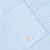 View 6 of product The Turnbull & Asser Light Blue Bengal Stripe Shirt features a T&A collar, double cuffs, and white buttons, offering British flair in blue and white stripes against a plain background.