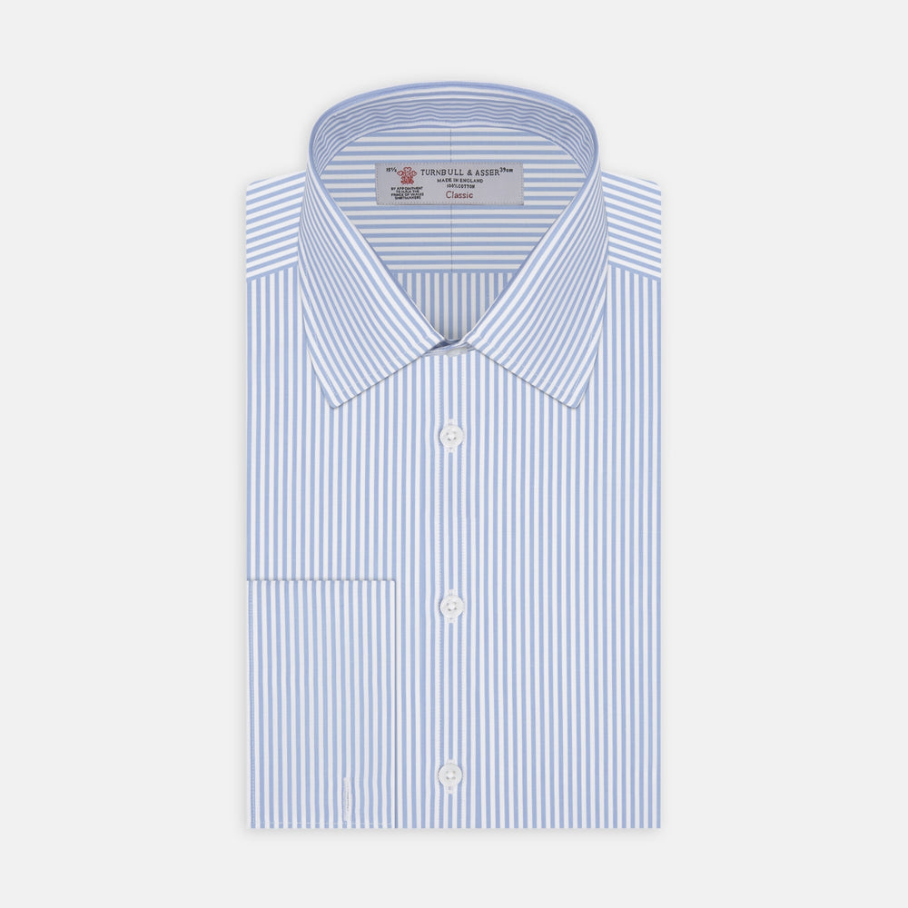 The Turnbull & Asser Light Blue Bengal Stripe Shirt features a T&A collar, double cuffs, and white buttons, offering British flair in blue and white stripes against a plain background.