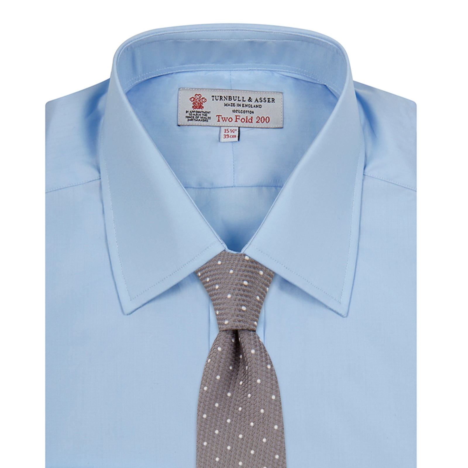 View 4 of product The Turnbull & Asser Two-Fold 200 Blue Cotton Shirt features a T&A collar, double cuffs, white buttons, and a visible label inside the collar, displayed neatly folded on a plain white background for superior breathability.