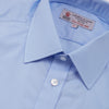 View 5 of product The Turnbull & Asser Two-Fold 200 Blue Cotton Shirt features a T&A collar, double cuffs, white buttons, and a visible label inside the collar, displayed neatly folded on a plain white background for superior breathability.