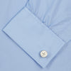 View 6 of product The Turnbull & Asser Two-Fold 200 Blue Cotton Shirt features a T&A collar, double cuffs, white buttons, and a visible label inside the collar, displayed neatly folded on a plain white background for superior breathability.