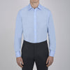 View 2 of product The Turnbull & Asser Two-Fold 200 Blue Cotton Shirt features a T&A collar, double cuffs, white buttons, and a visible label inside the collar, displayed neatly folded on a plain white background for superior breathability.