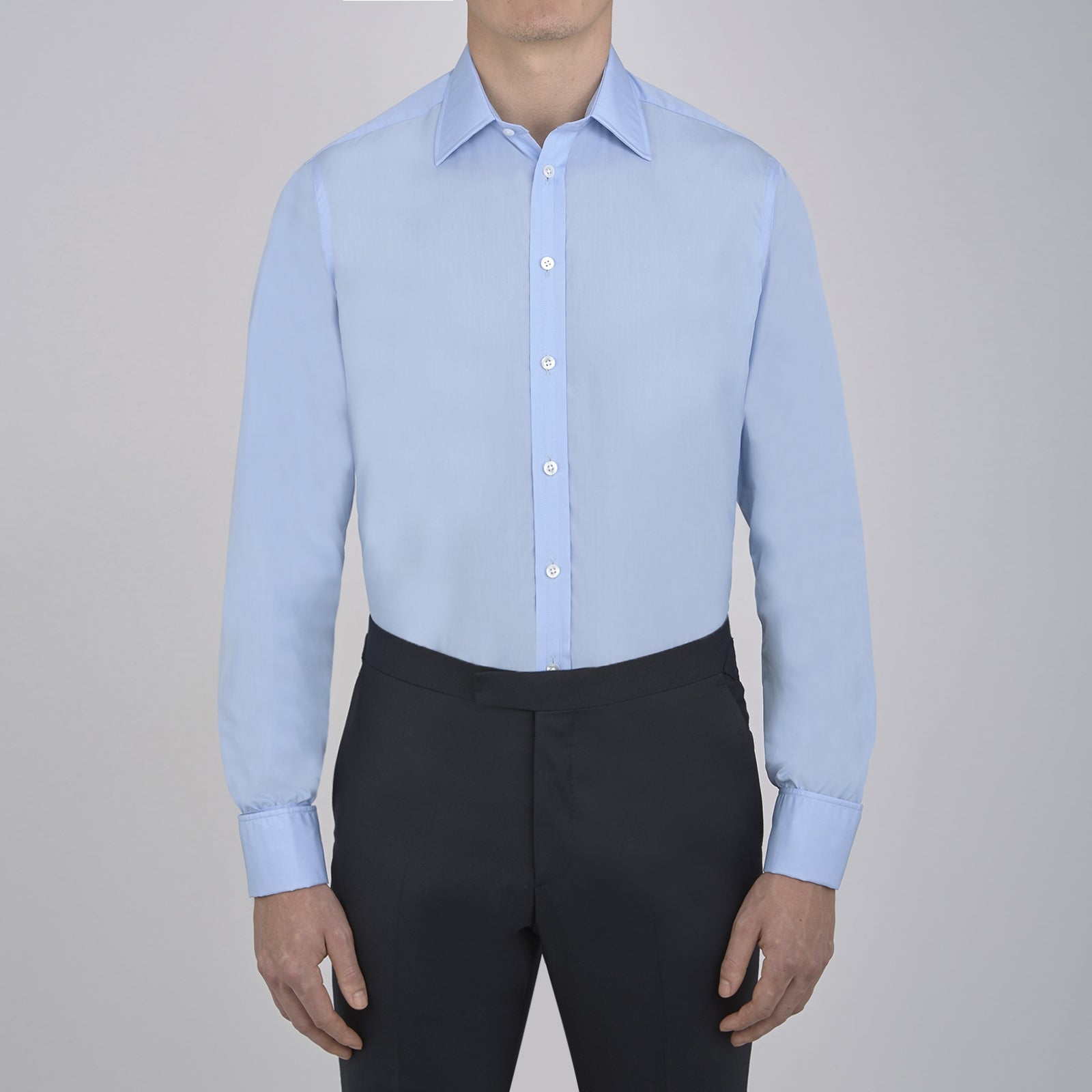 View 2 of product The Turnbull & Asser Two-Fold 200 Blue Cotton Shirt features a T&A collar, double cuffs, white buttons, and a visible label inside the collar, displayed neatly folded on a plain white background for superior breathability.